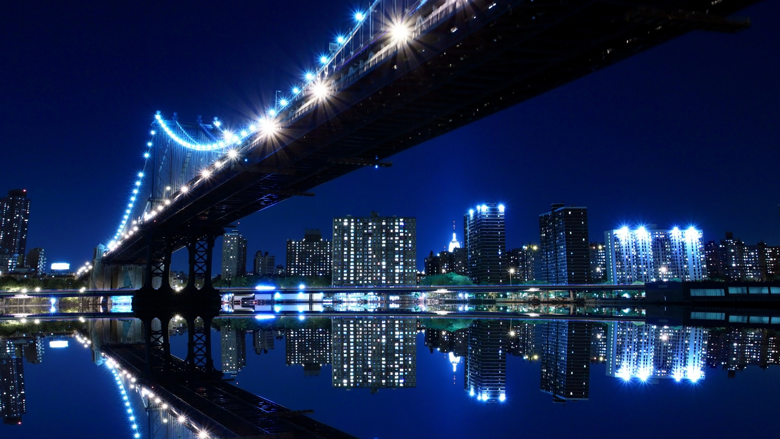Lighted Bridge Over Water During Night Time. Wallpaper in 2560x1440 Resolution