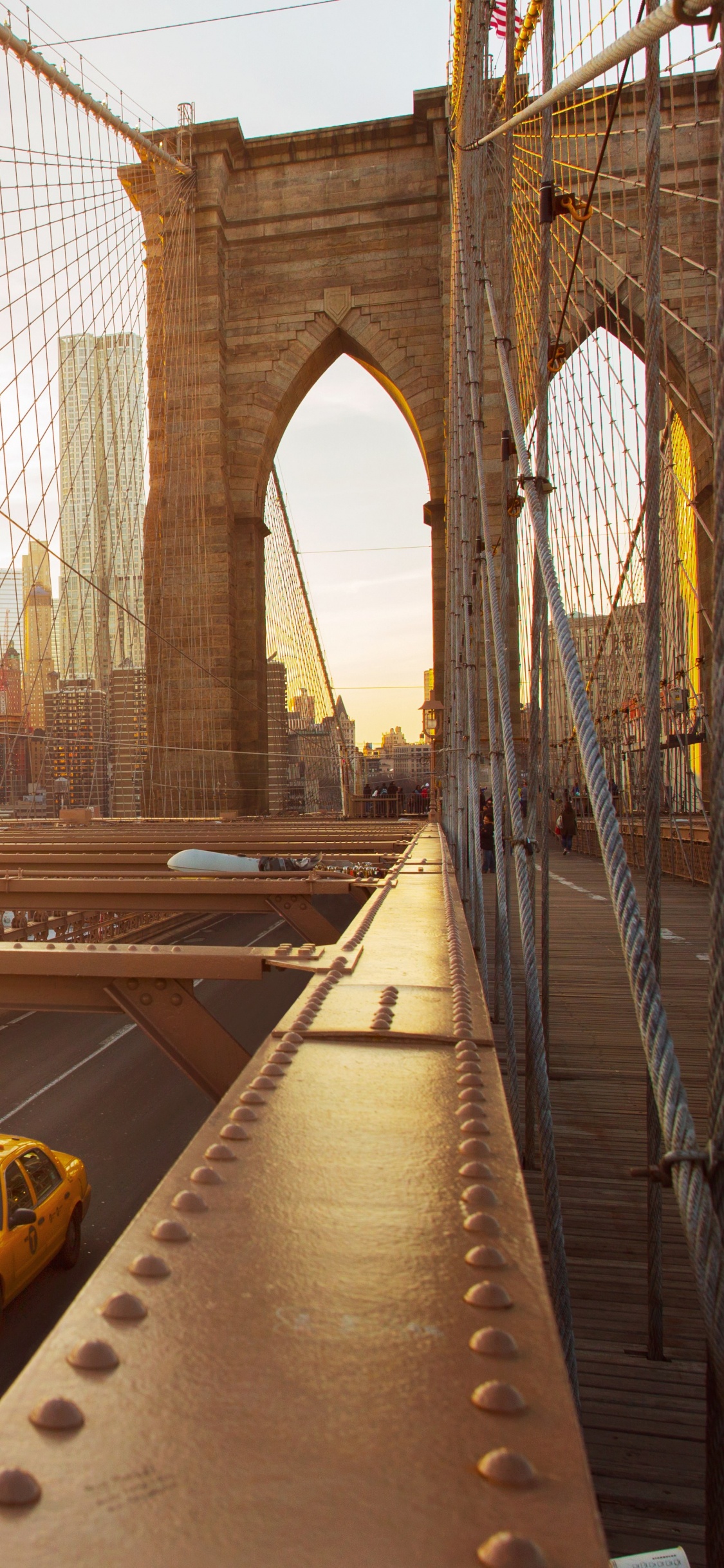 Yellow Car on Gray Concrete Bridge During Daytime. Wallpaper in 1125x2436 Resolution