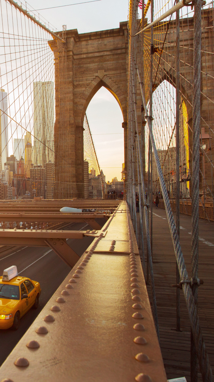 Yellow Car on Gray Concrete Bridge During Daytime. Wallpaper in 750x1334 Resolution