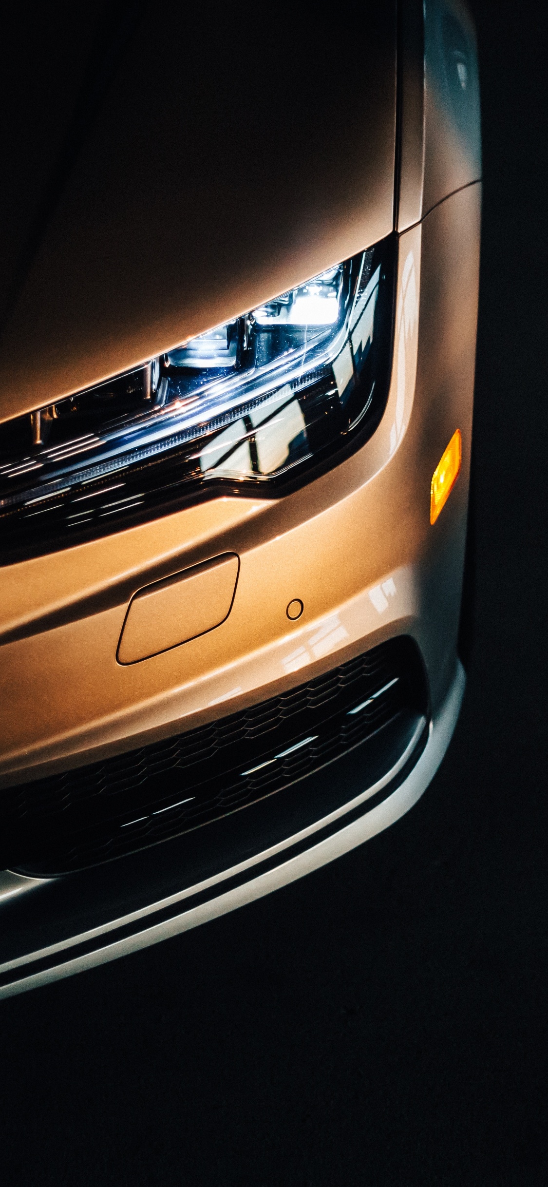 Black Car in a Dark Room. Wallpaper in 1125x2436 Resolution