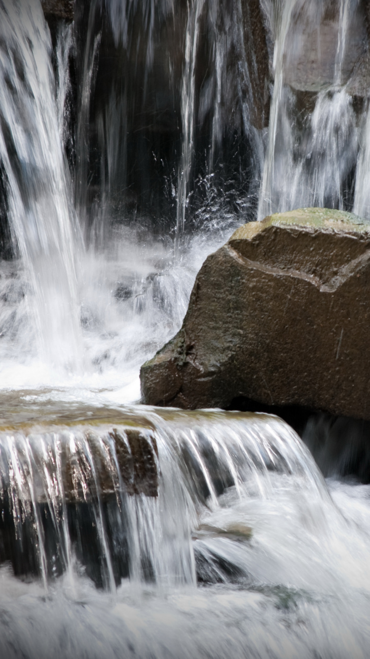 Brown Rock Formation With Water Falls. Wallpaper in 750x1334 Resolution