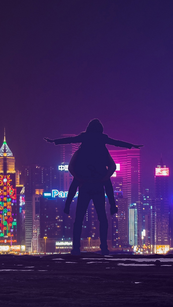 Man in Black Jacket Standing on The Street During Night Time. Wallpaper in 720x1280 Resolution