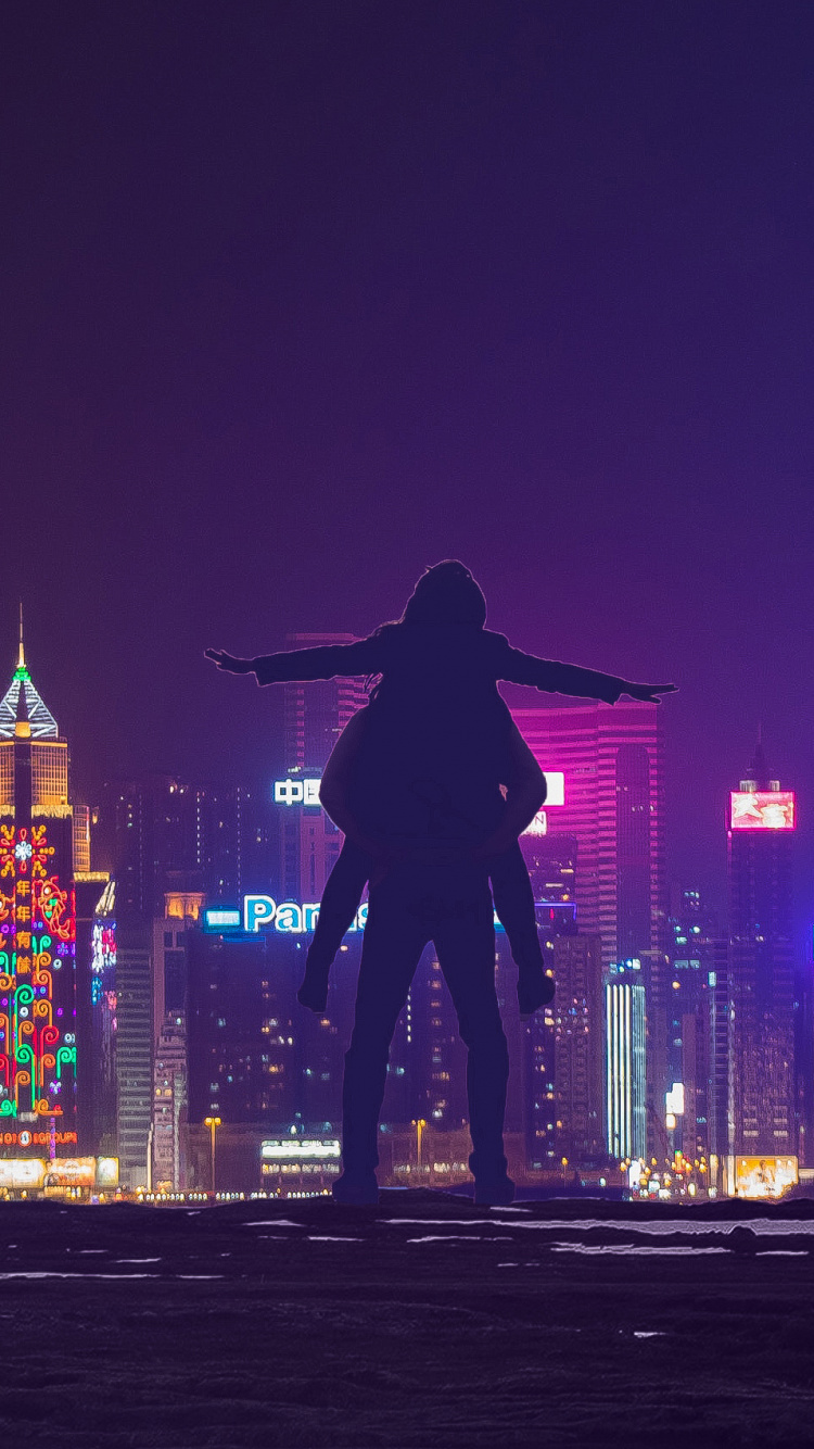 Man in Black Jacket Standing on The Street During Night Time. Wallpaper in 750x1334 Resolution