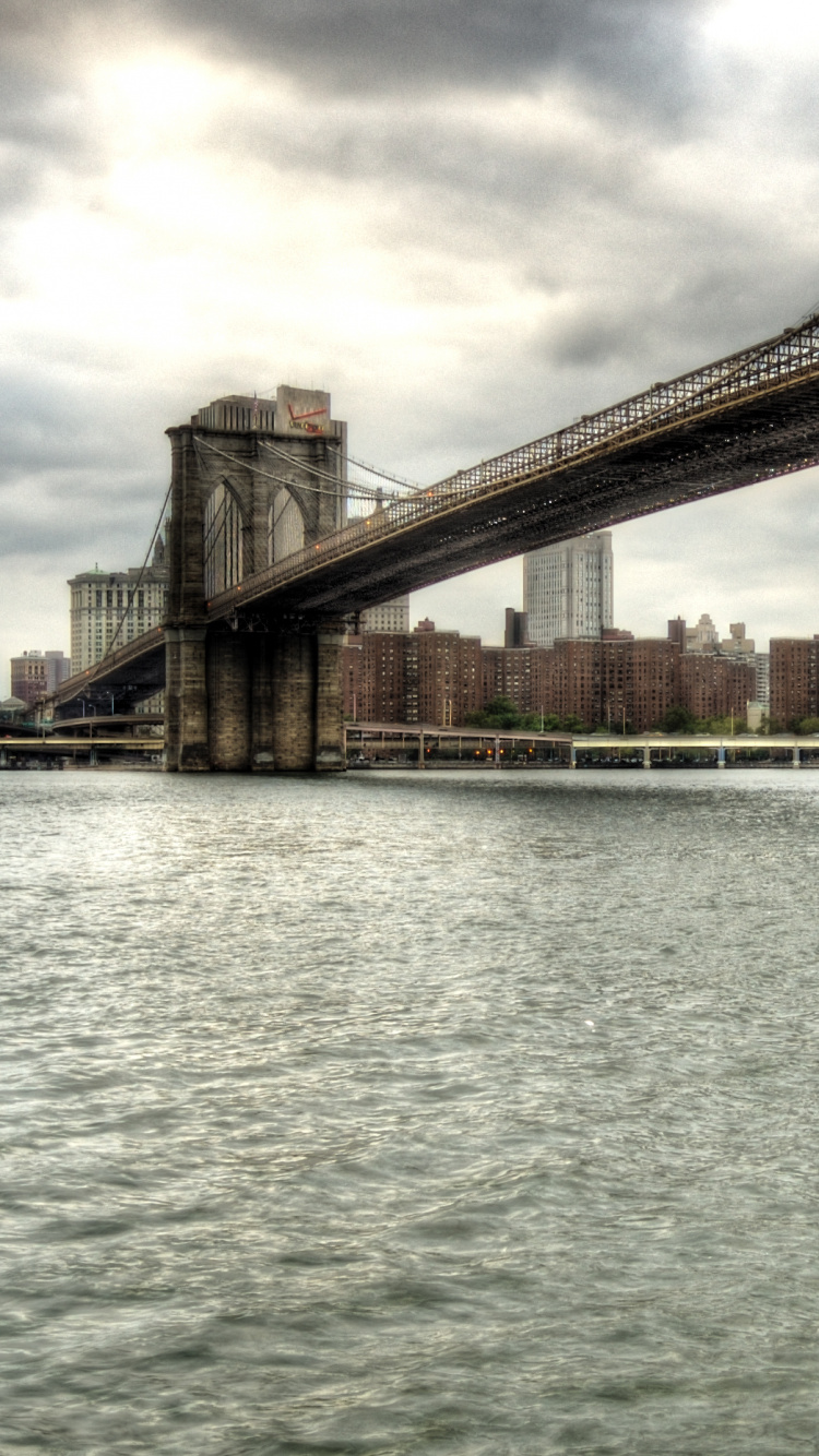 Brown Bridge Over Body of Water During Daytime. Wallpaper in 750x1334 Resolution