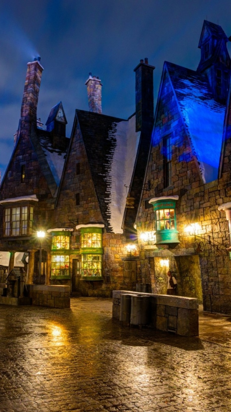 Brown and Blue Concrete Building Near Body of Water During Night Time. Wallpaper in 750x1334 Resolution