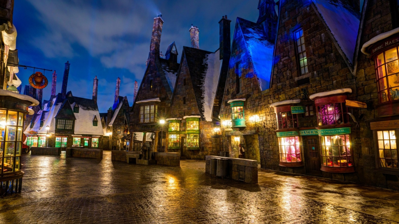 Bâtiment en Béton Marron et Bleu Près D'un Plan D'eau Pendant la Nuit. Wallpaper in 1366x768 Resolution