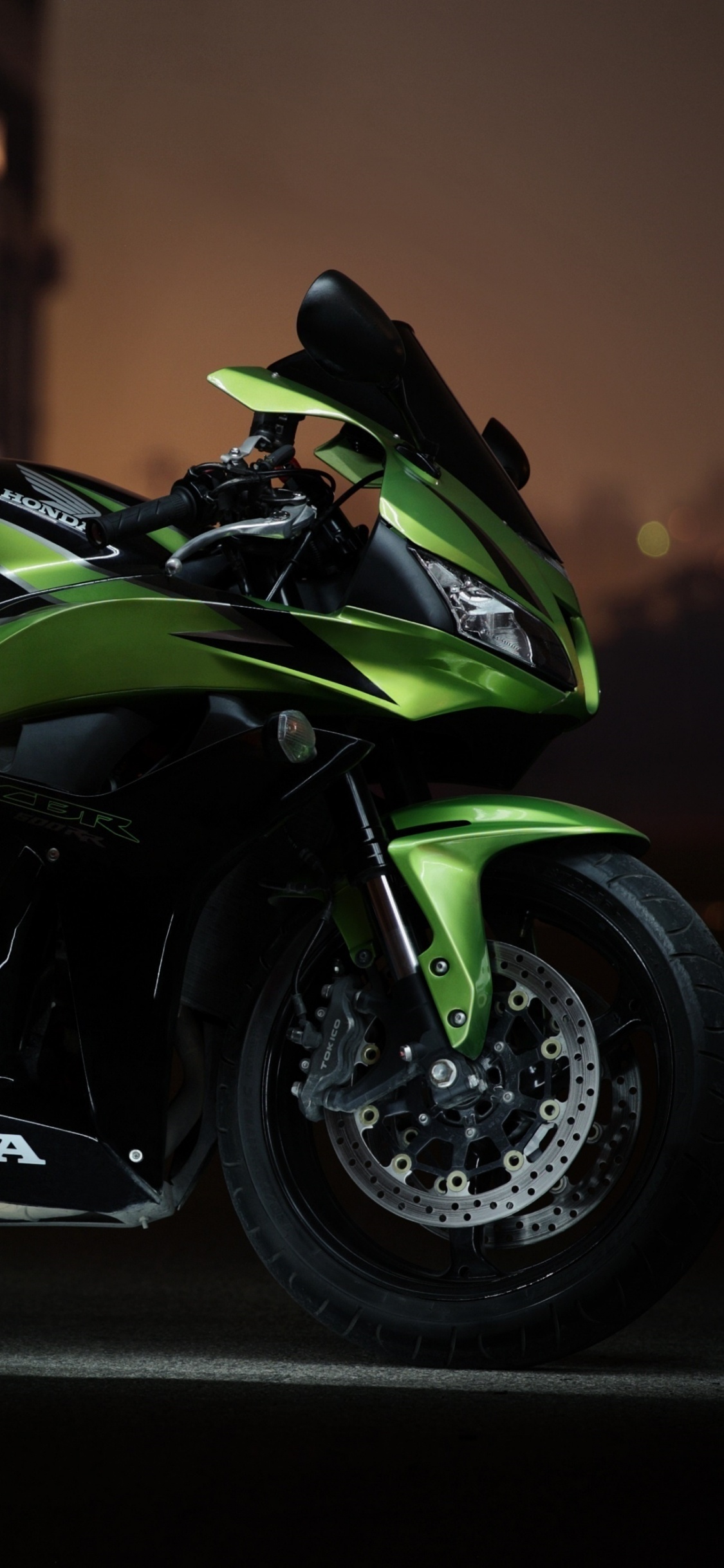 Black and Green Sports Bike Parked on Sidewalk During Daytime. Wallpaper in 1125x2436 Resolution