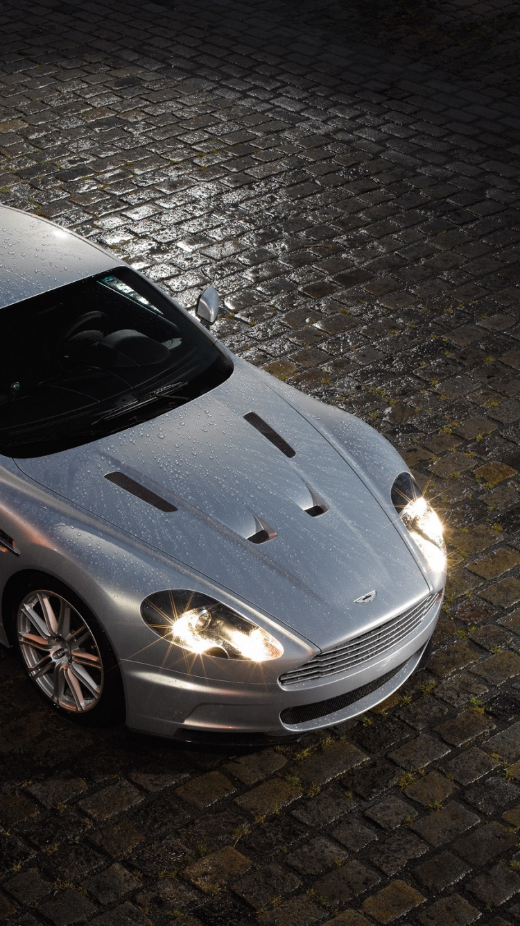 Silver Porsche 911 Parked on Gray Pavement. Wallpaper in 750x1334 Resolution