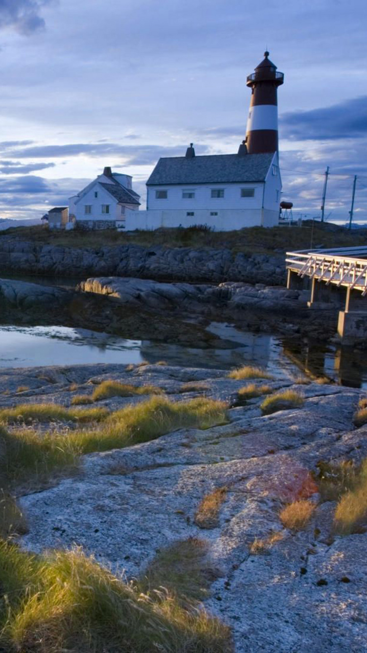 White Concrete Building on Green Grass Field Under White Clouds During Daytime. Wallpaper in 750x1334 Resolution