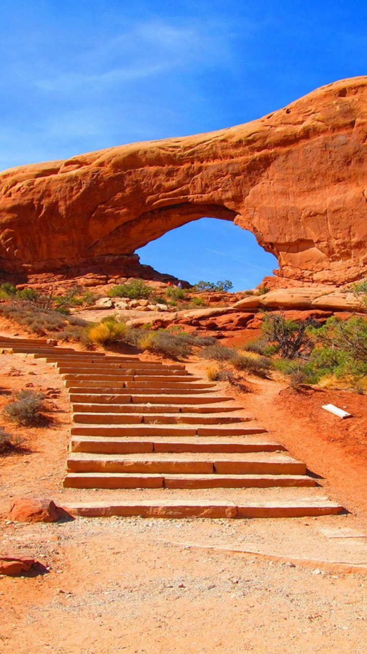 Escaleras de Madera Marrón Cerca de la Formación Rocosa Marrón Bajo un Cielo Azul Durante el Día. Wallpaper in 750x1334 Resolution