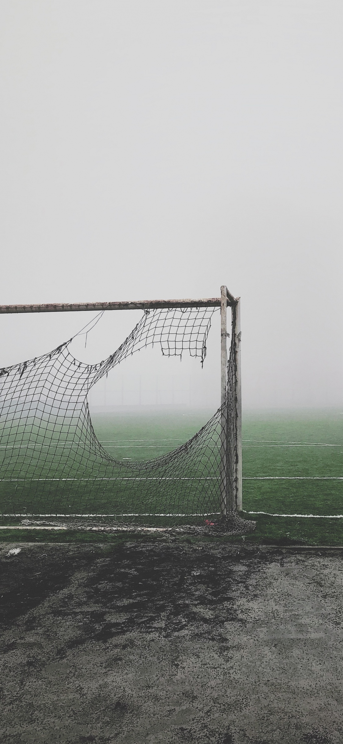 White Soccer Goal Net on Green Grass Field. Wallpaper in 1125x2436 Resolution