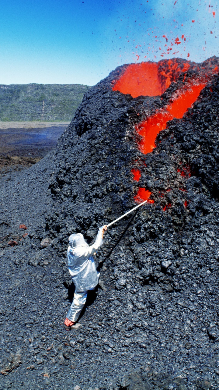 Man in White Jacket and Black Pants Standing on Rocky Hill During Daytime. Wallpaper in 720x1280 Resolution