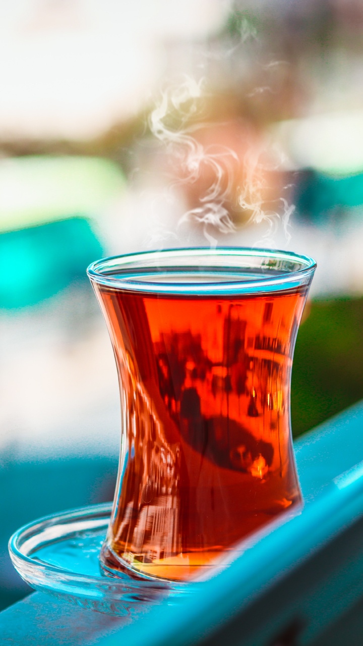 Clear Drinking Glass on Blue Car Hood. Wallpaper in 720x1280 Resolution