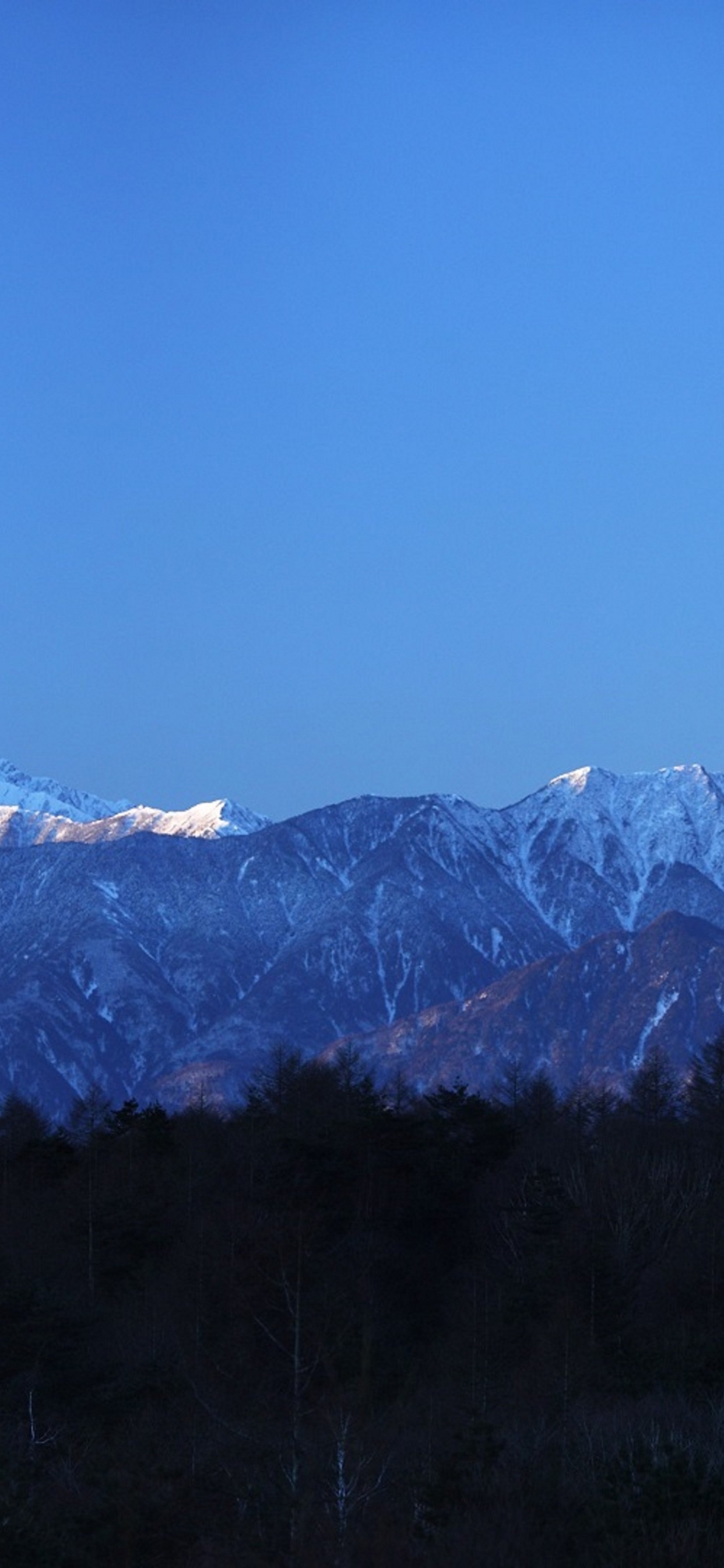 Snow Covered Mountain Under Blue Sky During Daytime. Wallpaper in 1242x2688 Resolution