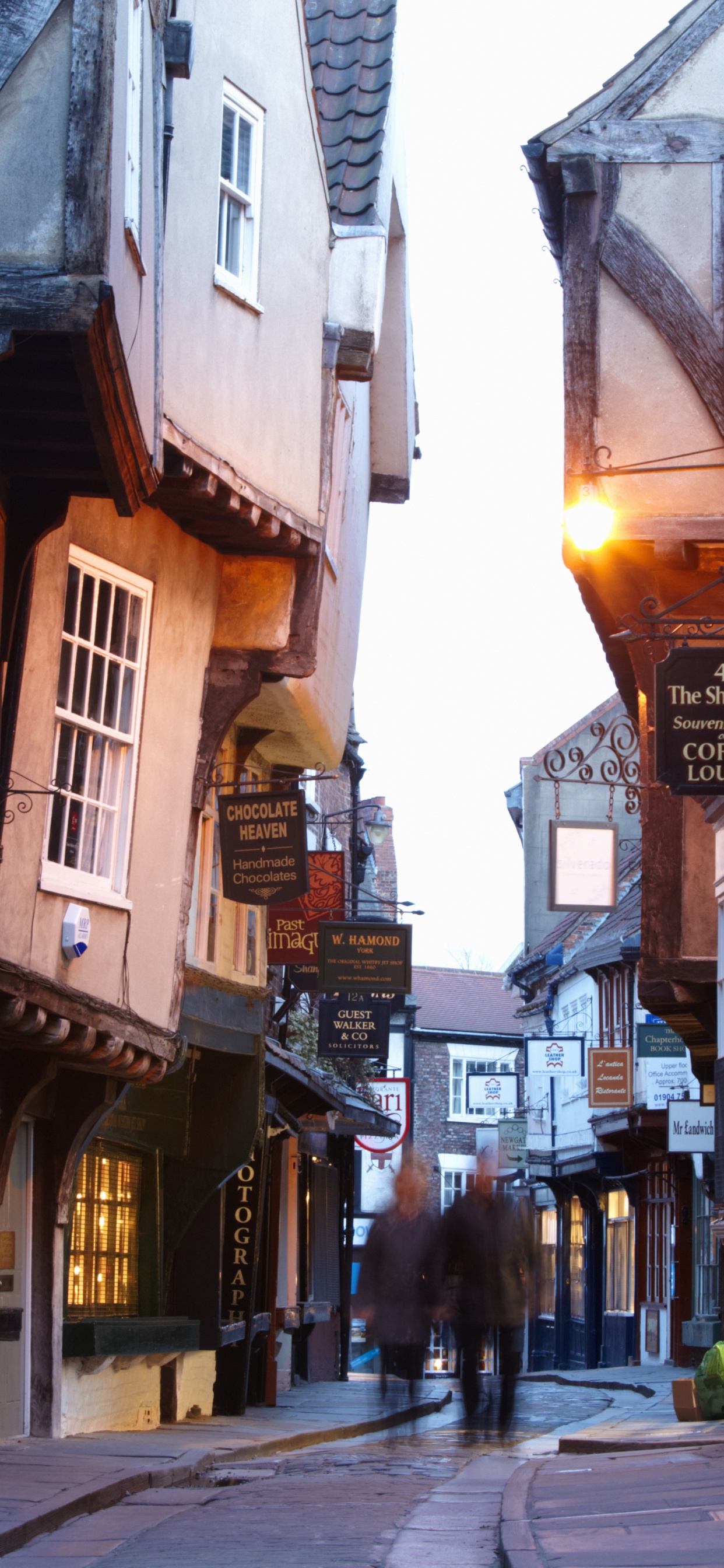 People Walking on Street Between Buildings During Daytime. Wallpaper in 1242x2688 Resolution
