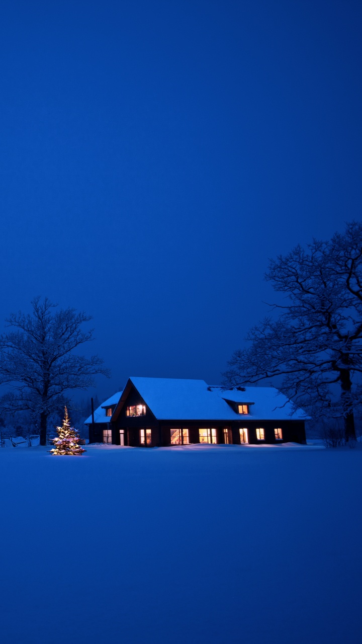 Braunes Holzhaus Auf Schneebedecktem Boden Während Der Nacht. Wallpaper in 720x1280 Resolution