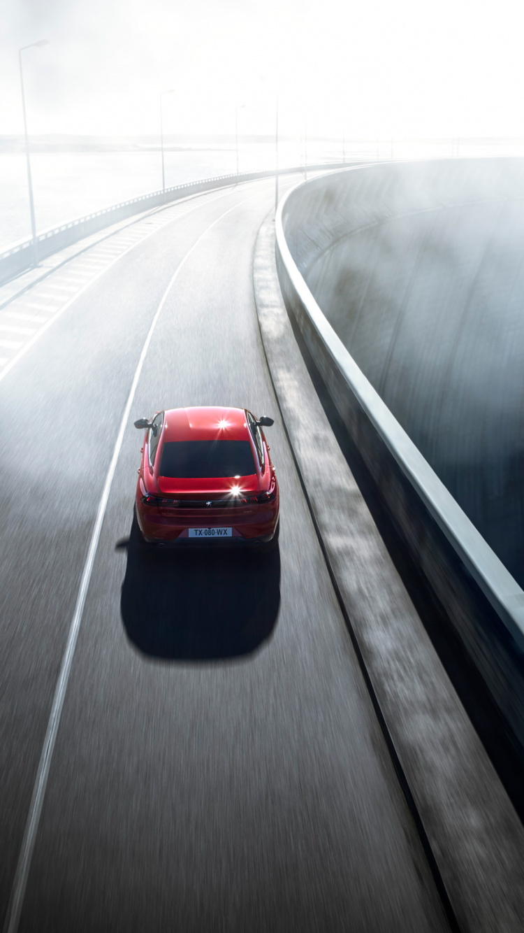 Rotes Auto Tagsüber Unterwegs. Wallpaper in 750x1334 Resolution