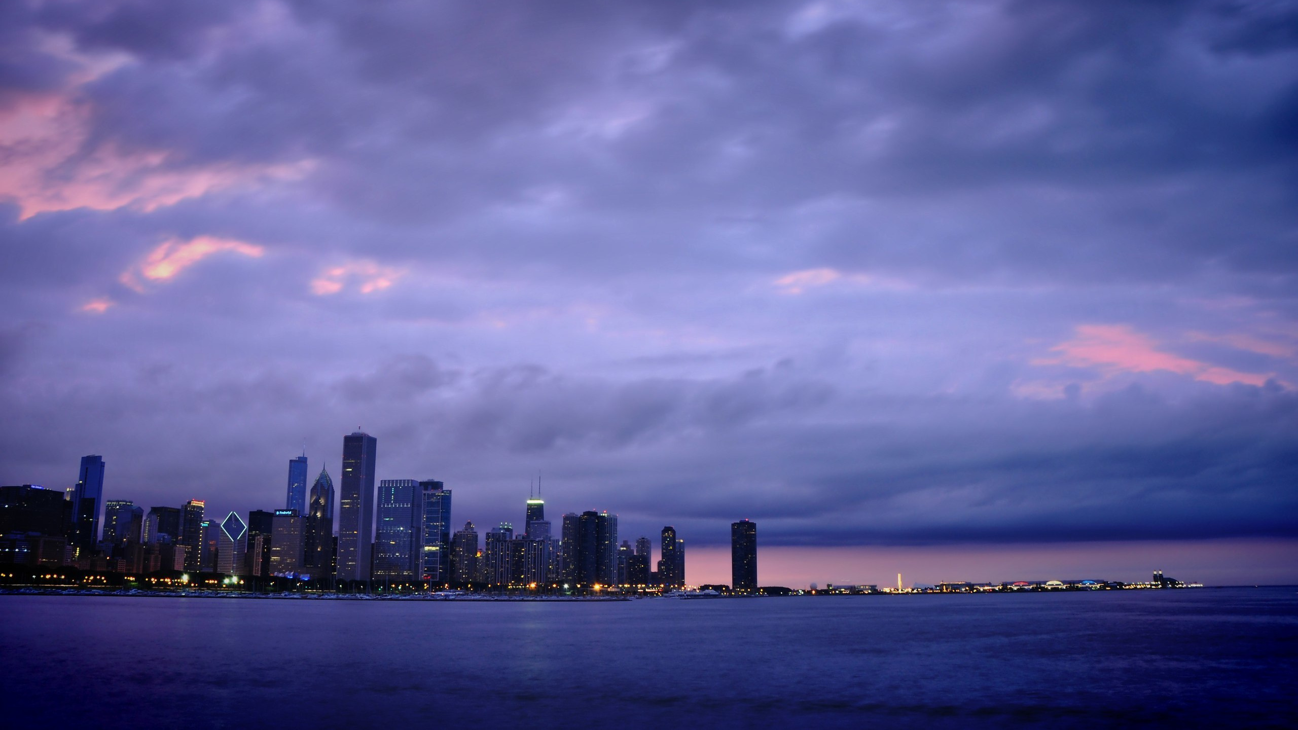 City Skyline Across Body of Water During Daytime. Wallpaper in 2560x1440 Resolution