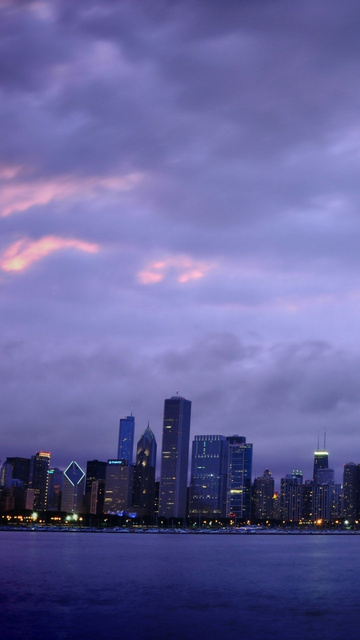 City Skyline Across Body of Water During Daytime. Wallpaper in 720x1280 Resolution