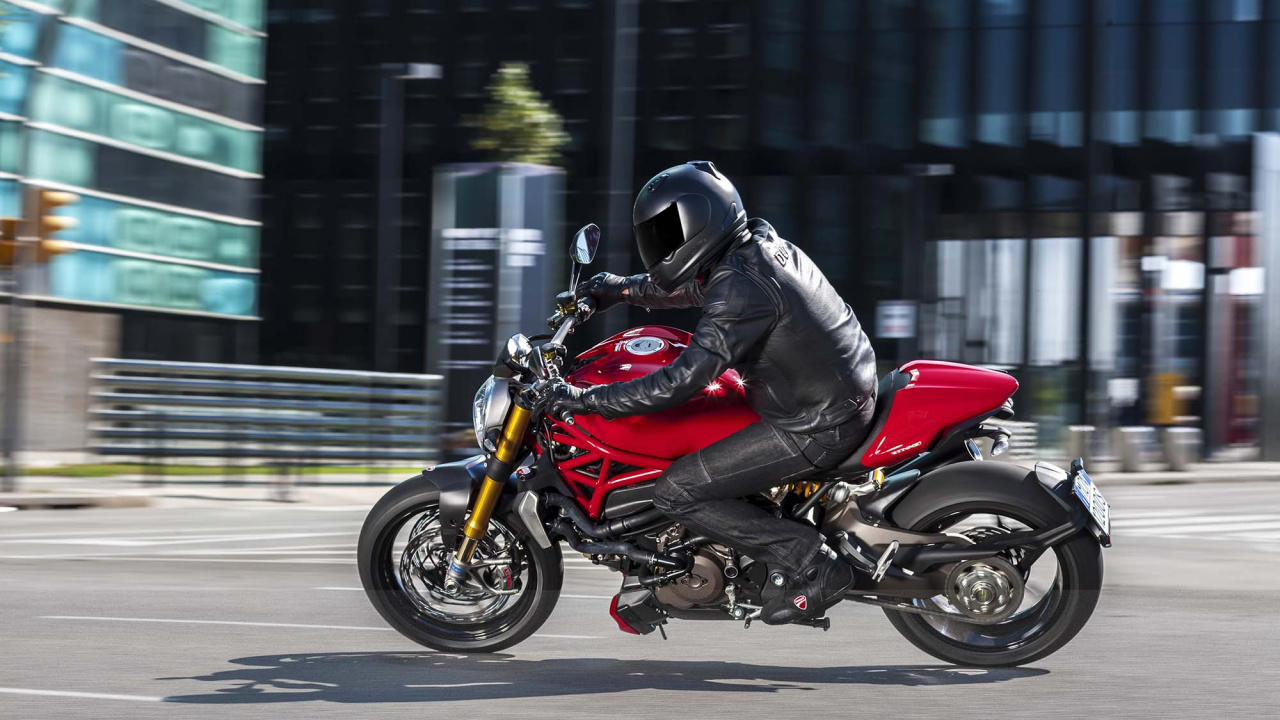 Man in Black Jacket Riding Red and Black Sports Bike. Wallpaper in 1280x720 Resolution