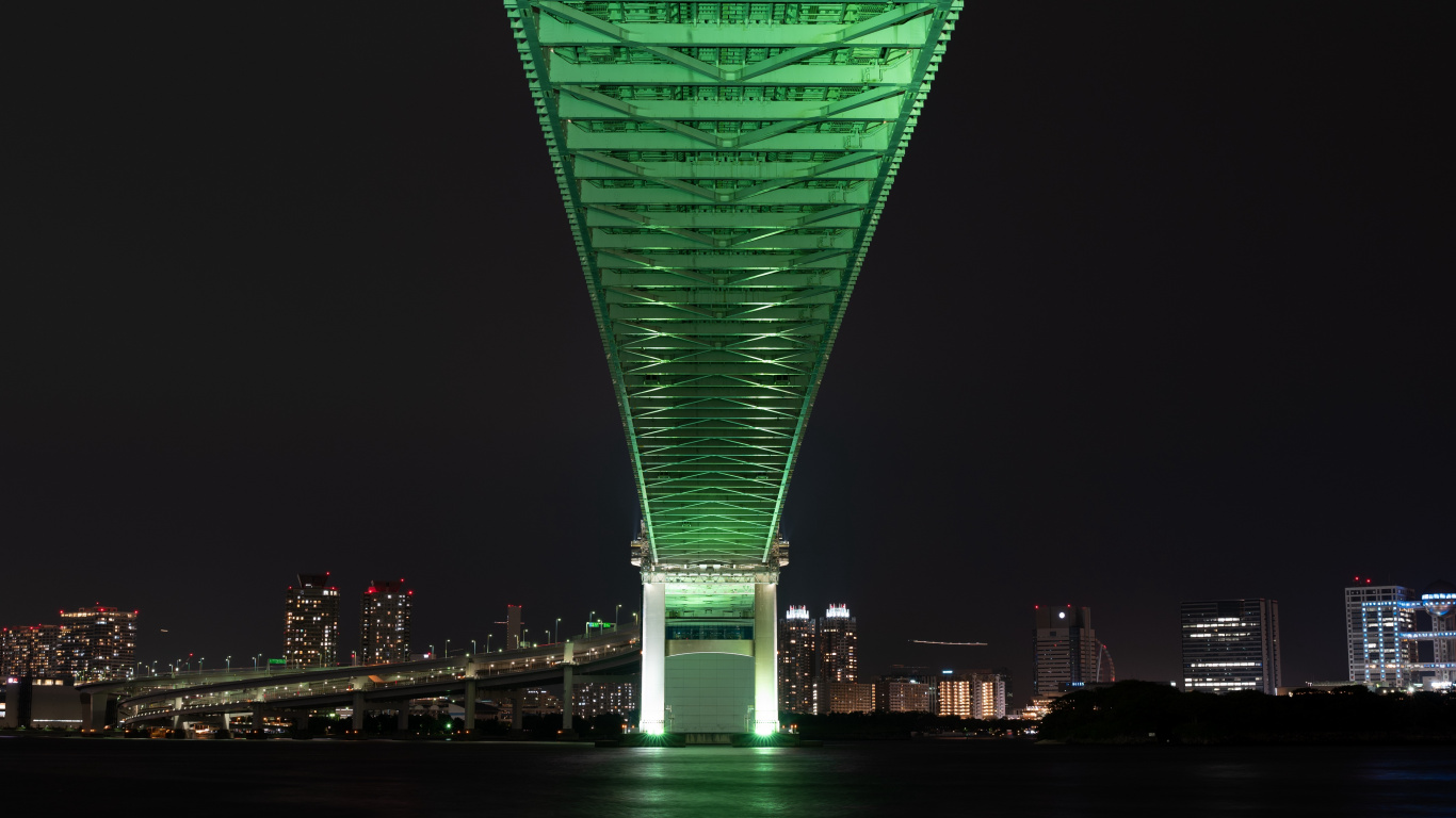 Green Bridge Over Body of Water During Night Time. Wallpaper in 1366x768 Resolution
