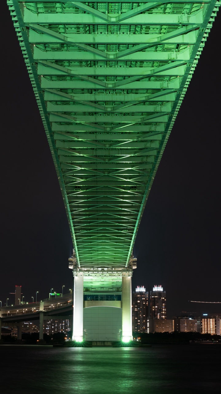 Green Bridge Over Body of Water During Night Time. Wallpaper in 720x1280 Resolution