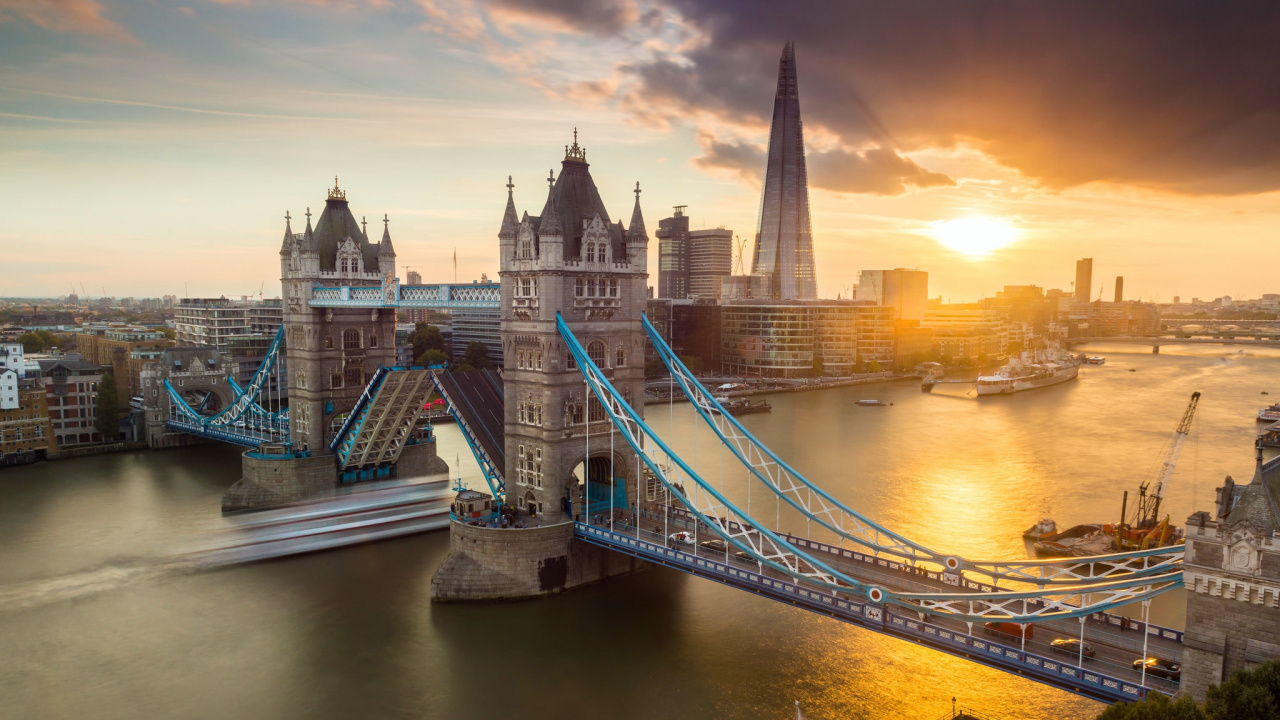 Bridge Over River Near City Buildings During Night Time. Wallpaper in 1280x720 Resolution