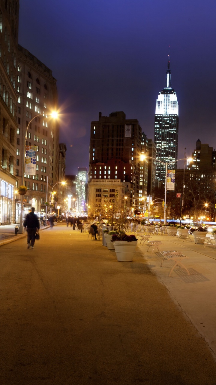 People Walking on Sidewalk Near Building During Night Time. Wallpaper in 720x1280 Resolution