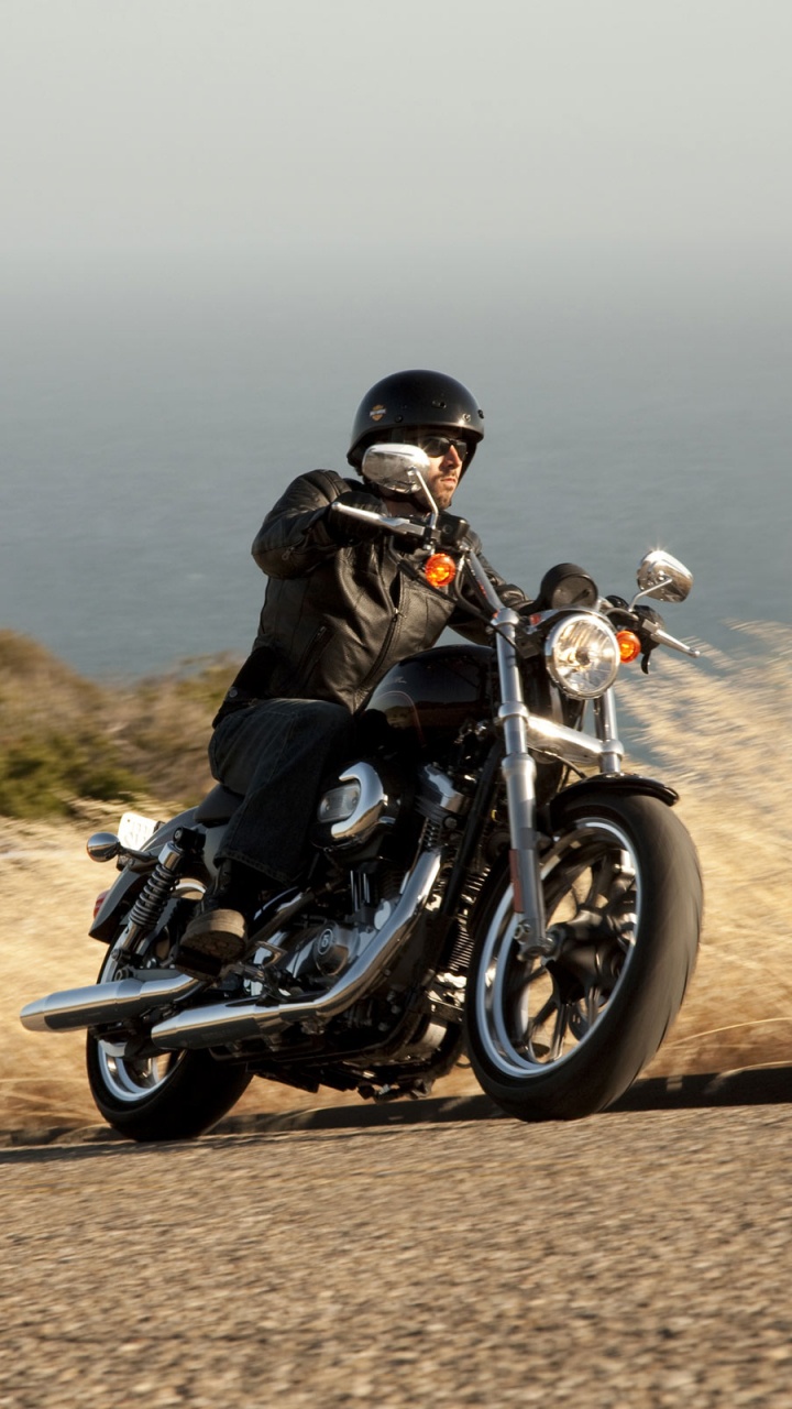 Man in Black Jacket Riding Black Motorcycle on Brown Field During Daytime. Wallpaper in 720x1280 Resolution