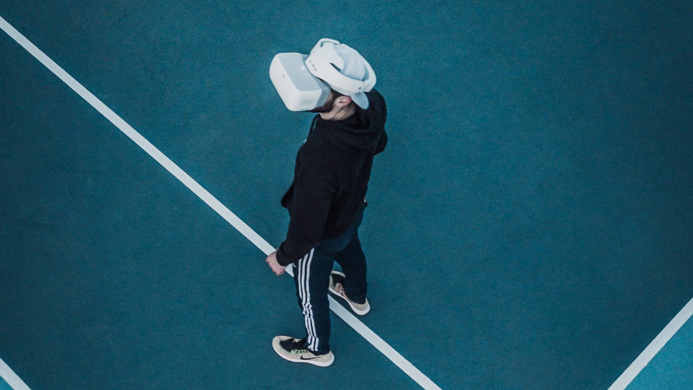 Person in Black Jacket and White Hat Playing on Green Floor. Wallpaper in 1366x768 Resolution