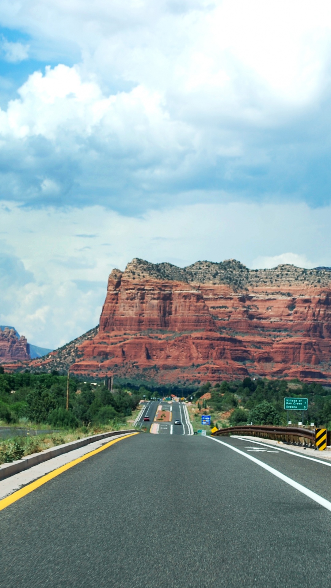 Gray Asphalt Road Near Brown Rock Formation Under White Clouds During Daytime. Wallpaper in 1080x1920 Resolution