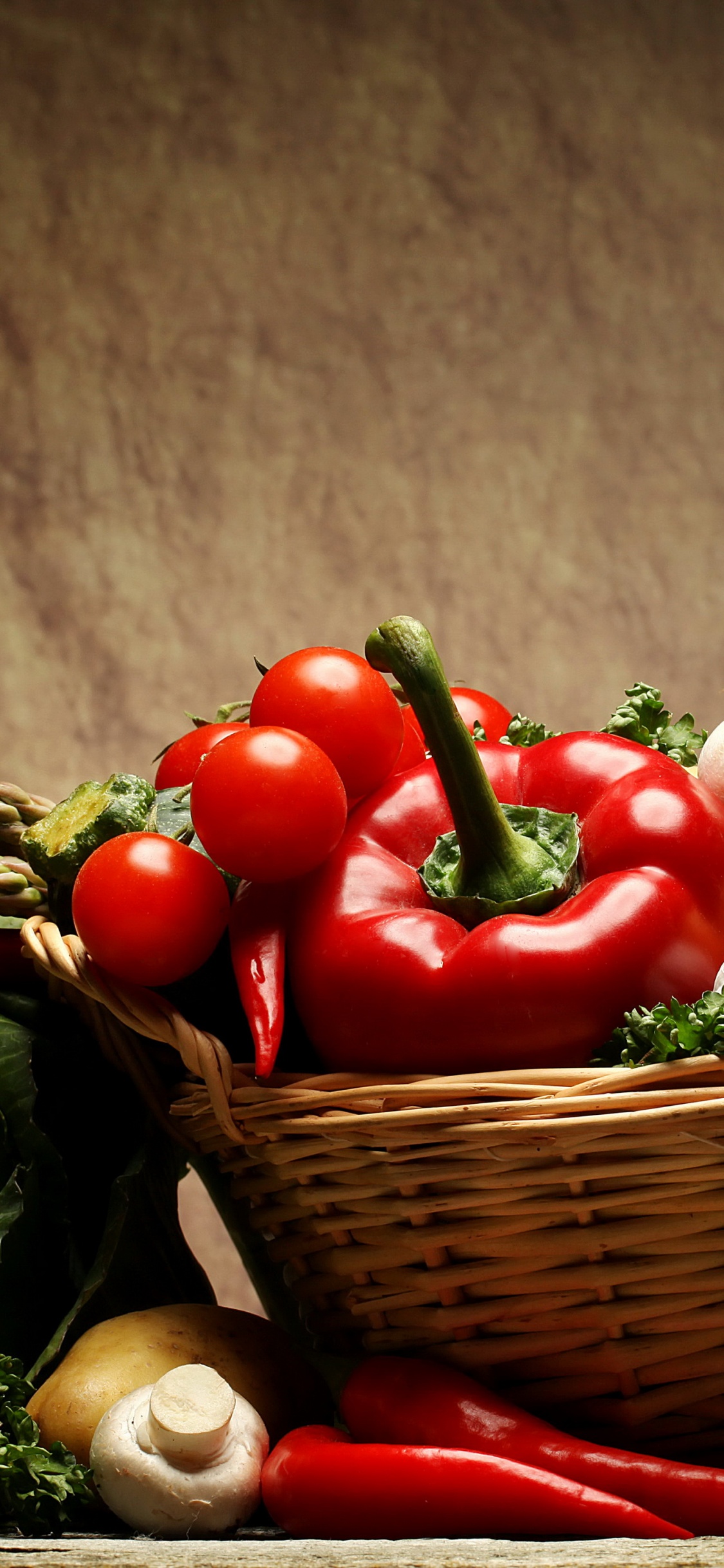 Red Tomatoes and Green Vegetable on Brown Woven Basket. Wallpaper in 1125x2436 Resolution