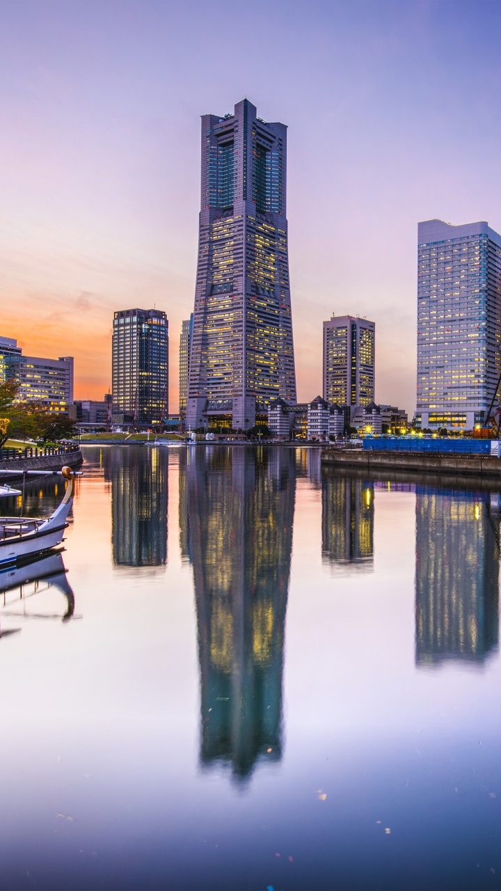 City Skyline Across Body of Water During Night Time. Wallpaper in 720x1280 Resolution