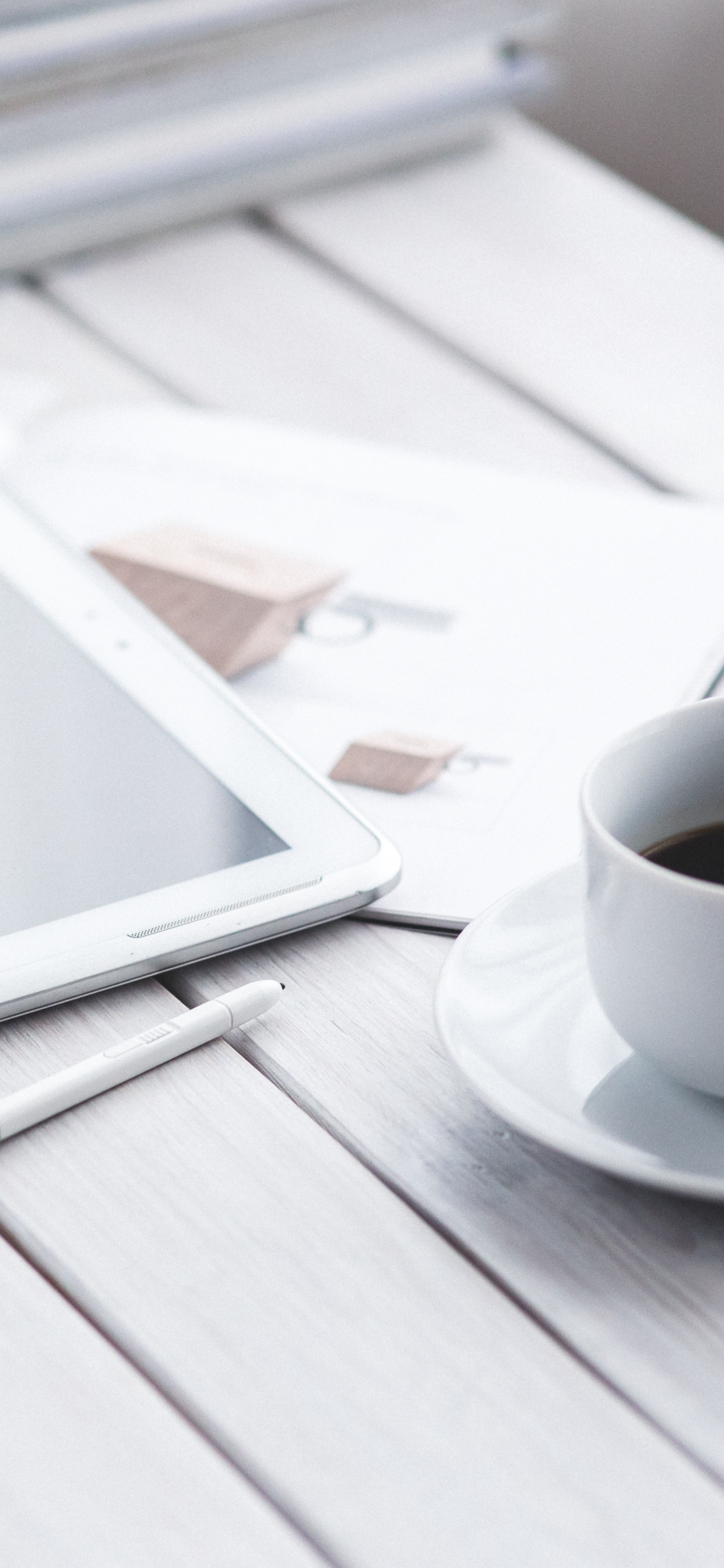 White Ipad on White Book Page Beside White Ceramic Mug on Table. Wallpaper in 1242x2688 Resolution