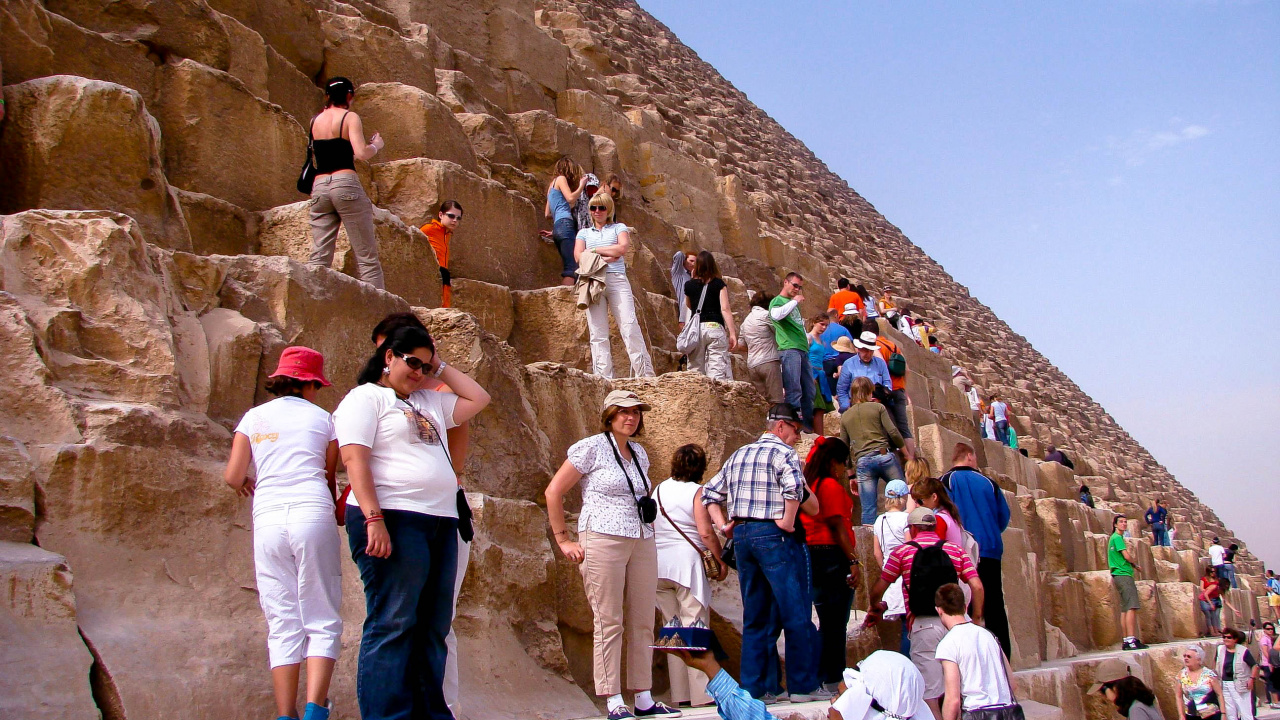 Group of People Standing on Brown Rock Formation During Daytime. Wallpaper in 1280x720 Resolution