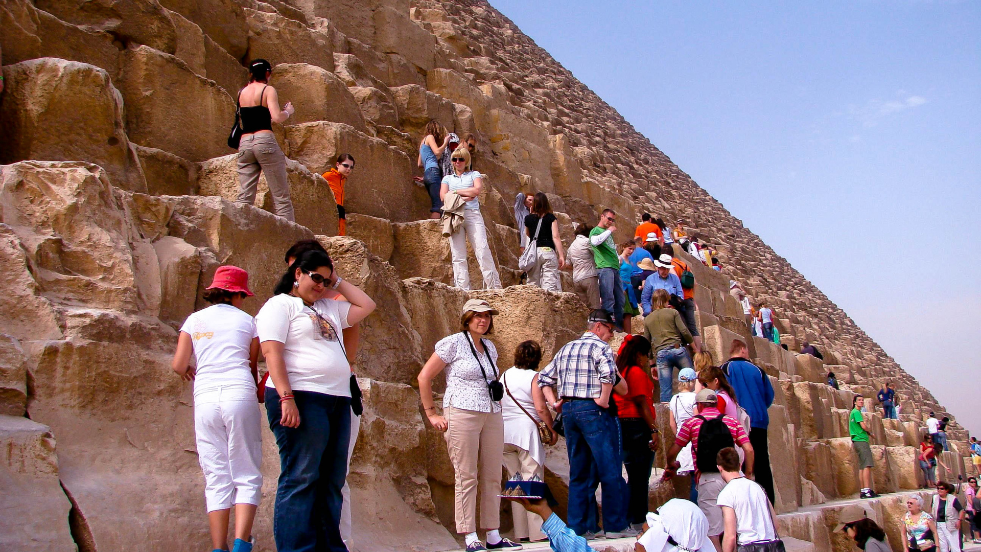 Group of People Standing on Brown Rock Formation During Daytime. Wallpaper in 1920x1080 Resolution
