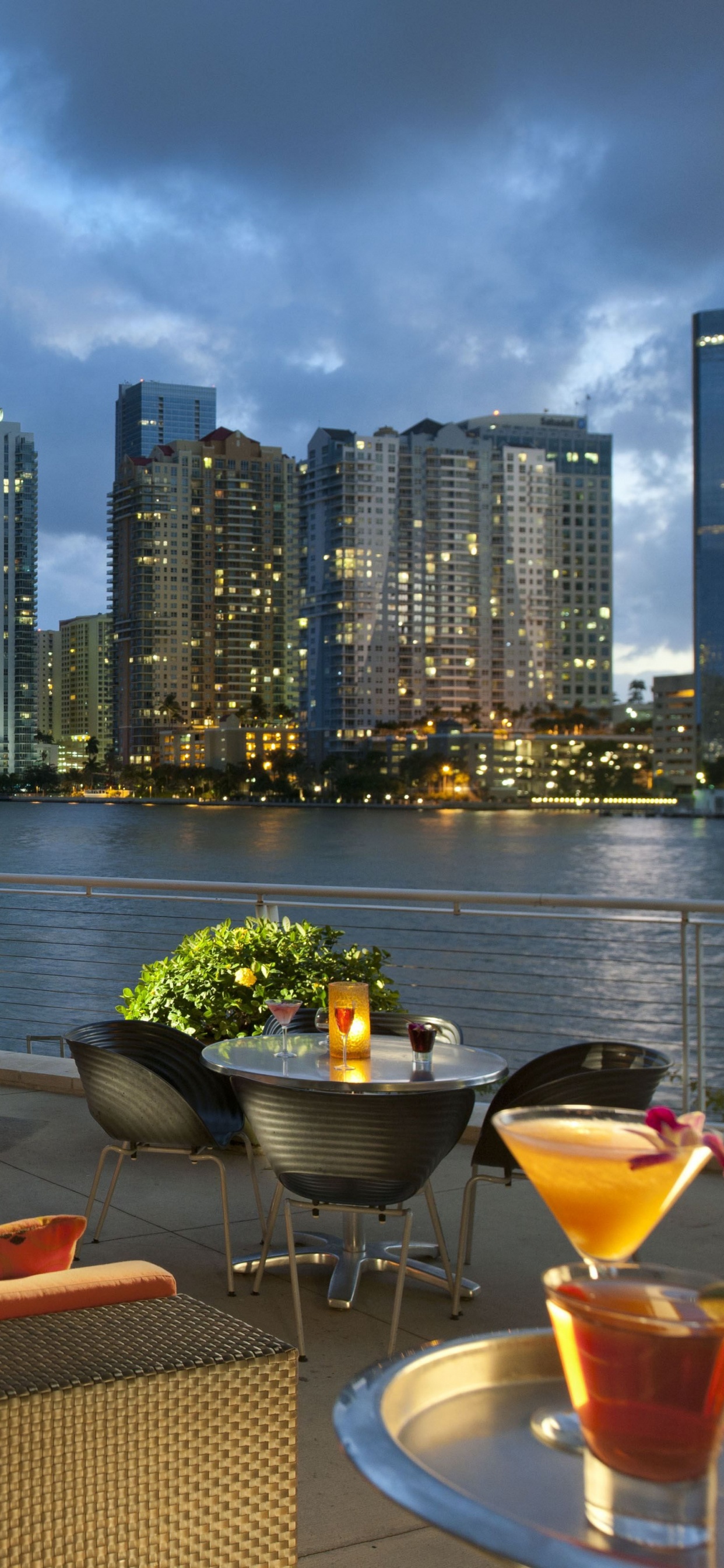 Brown and Black Chairs and Table Near Body of Water During Daytime. Wallpaper in 1242x2688 Resolution