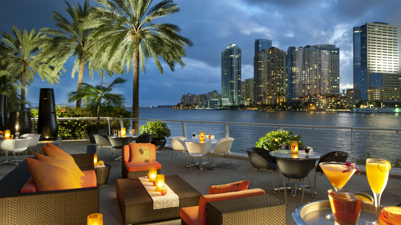 Brown and Black Chairs and Table Near Body of Water During Daytime. Wallpaper in 1280x720 Resolution