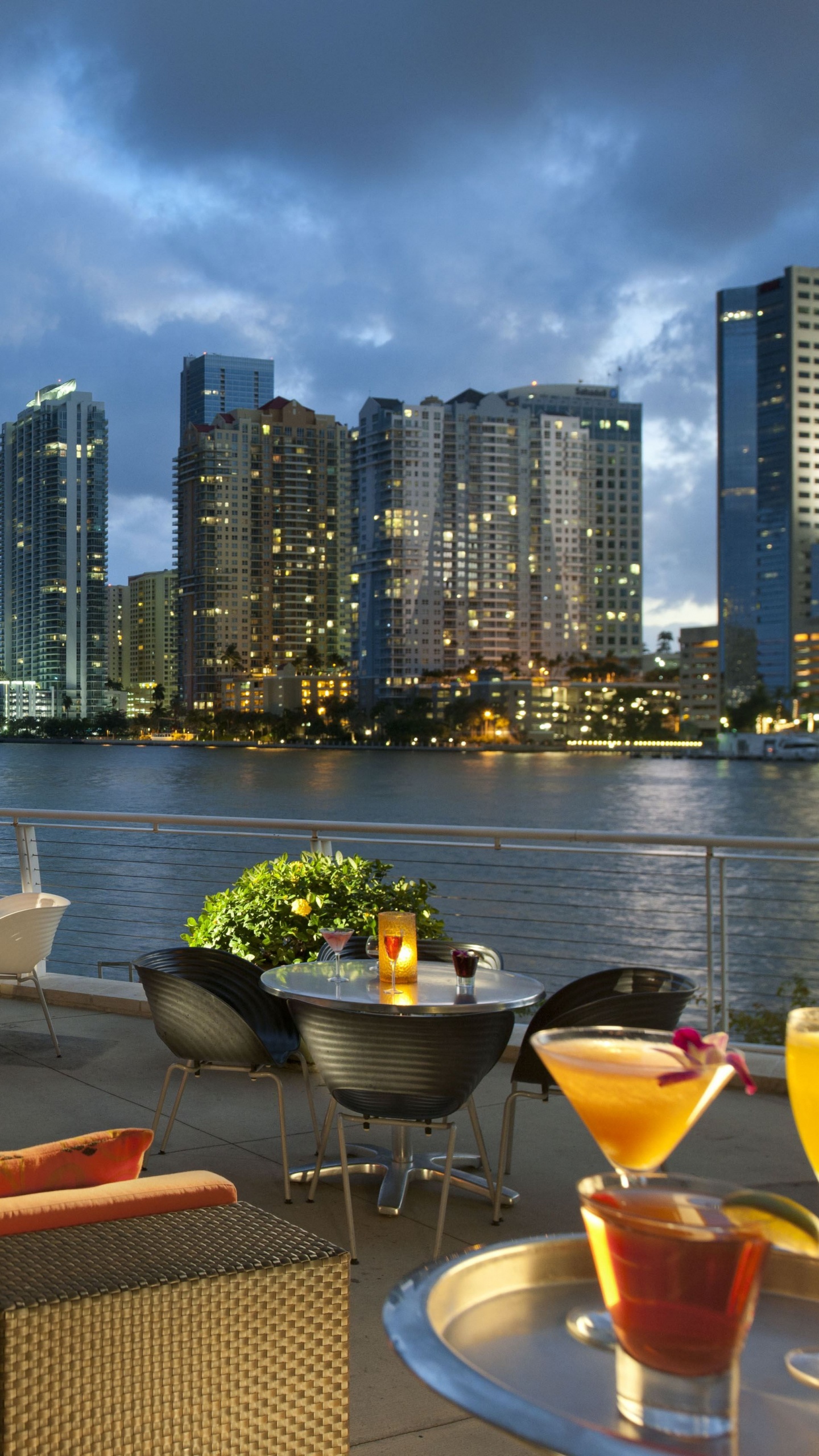 Brown and Black Chairs and Table Near Body of Water During Daytime. Wallpaper in 1440x2560 Resolution