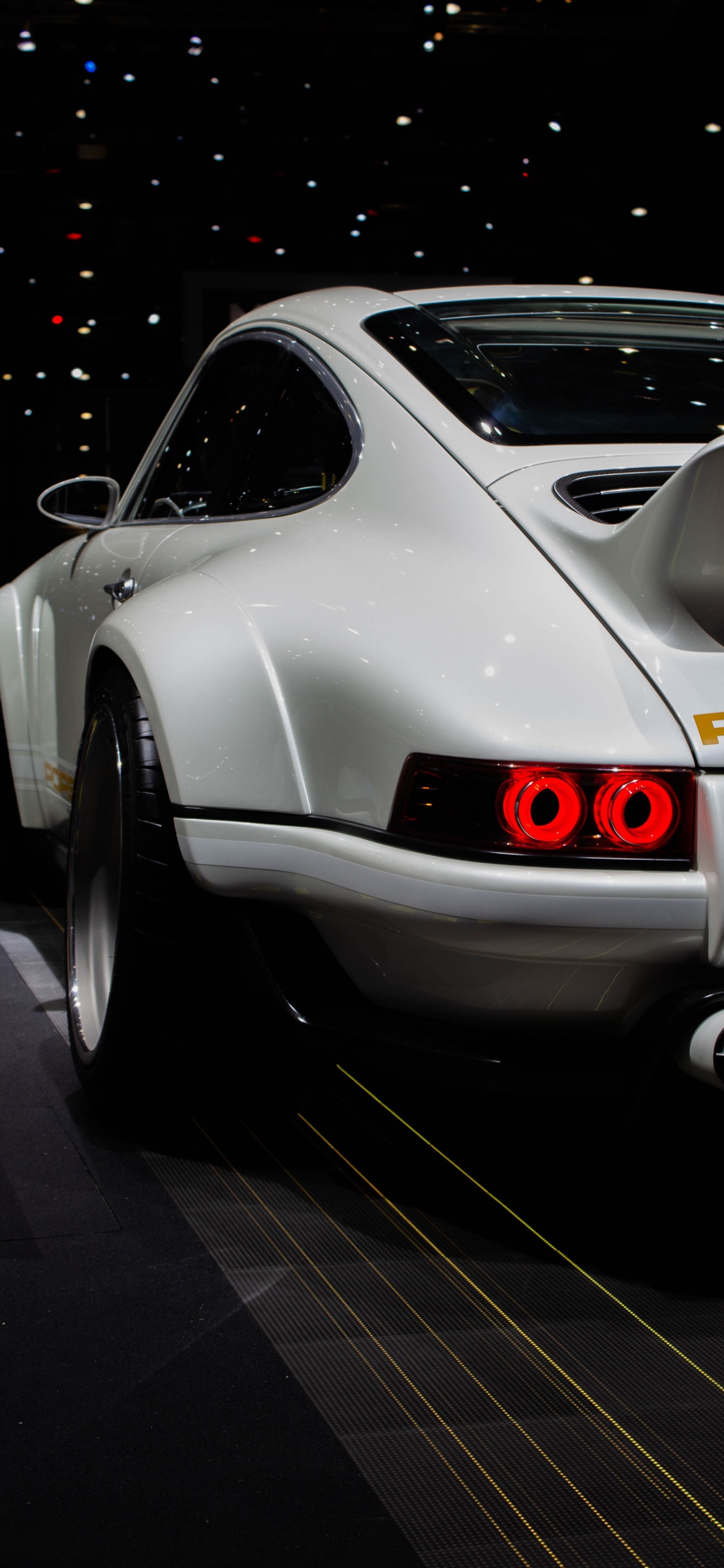 Silver Porsche 911 Parked on Parking Lot. Wallpaper in 1125x2436 Resolution