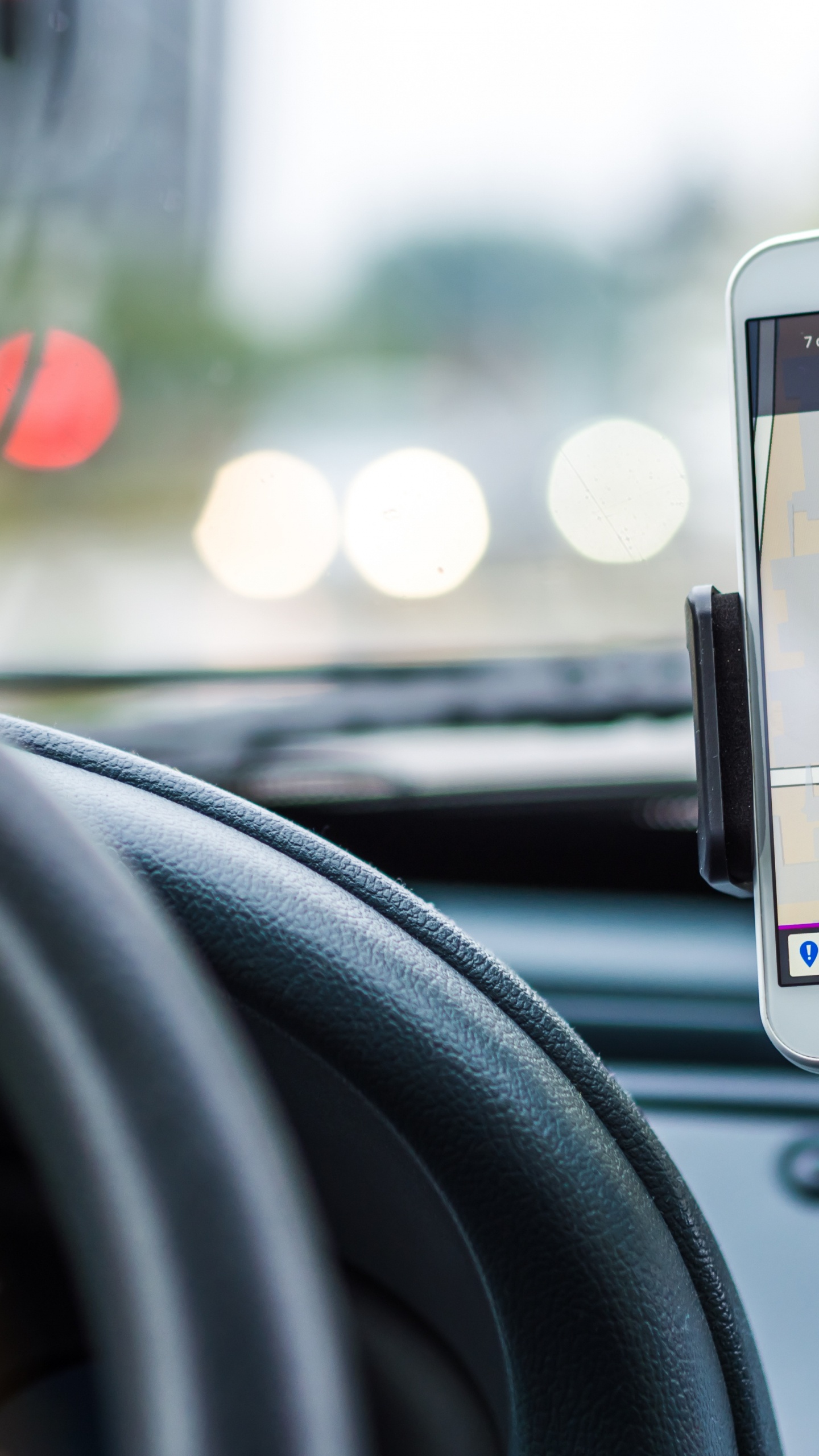 Silver Iphone 6 on Car Steering Wheel. Wallpaper in 1440x2560 Resolution