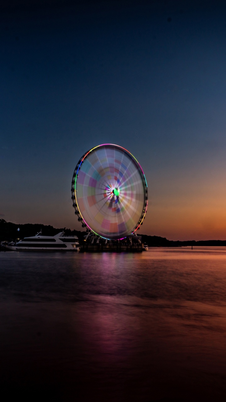 Ferris Wheel Near Body of Water During Night Time. Wallpaper in 720x1280 Resolution