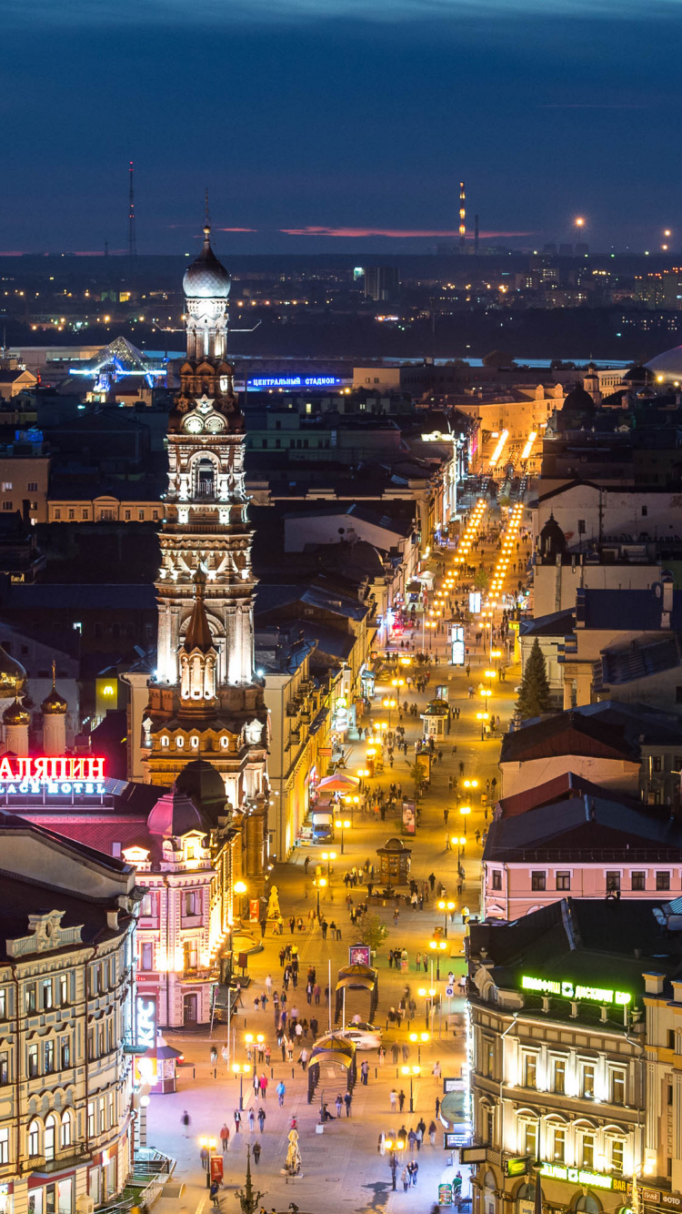 Yellow Lighted Tower in The City During Night Time. Wallpaper in 750x1334 Resolution
