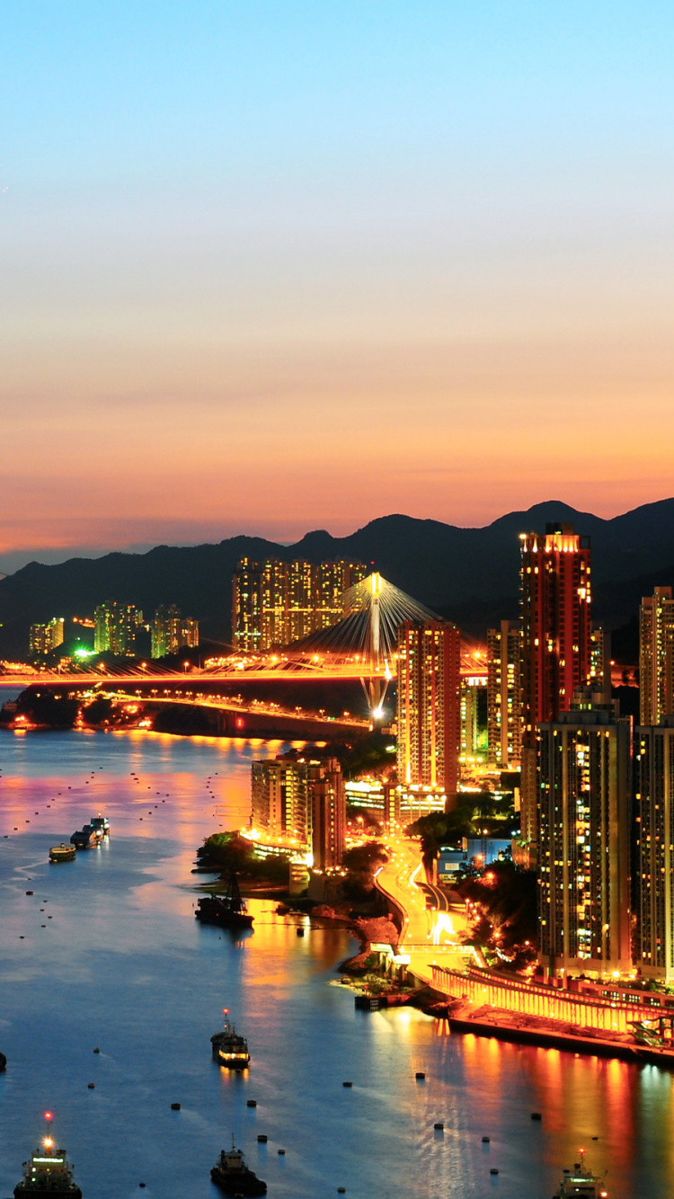 Gente en la Playa Cerca Del Puente Durante la Noche. Wallpaper in 750x1334 Resolution