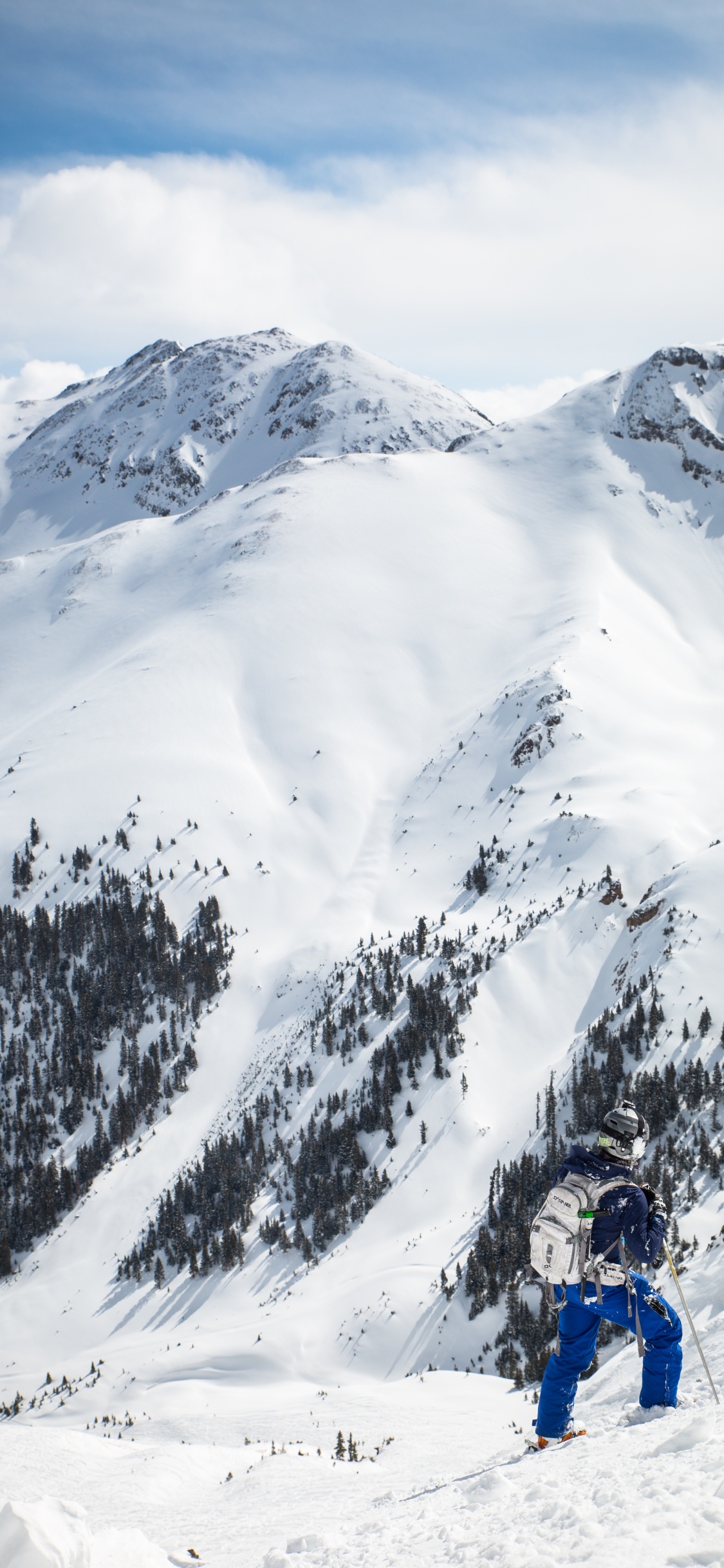 Persona Montando en Esquí de Nieve en Montañas Cubiertas de Nieve Durante el Día. Wallpaper in 1125x2436 Resolution