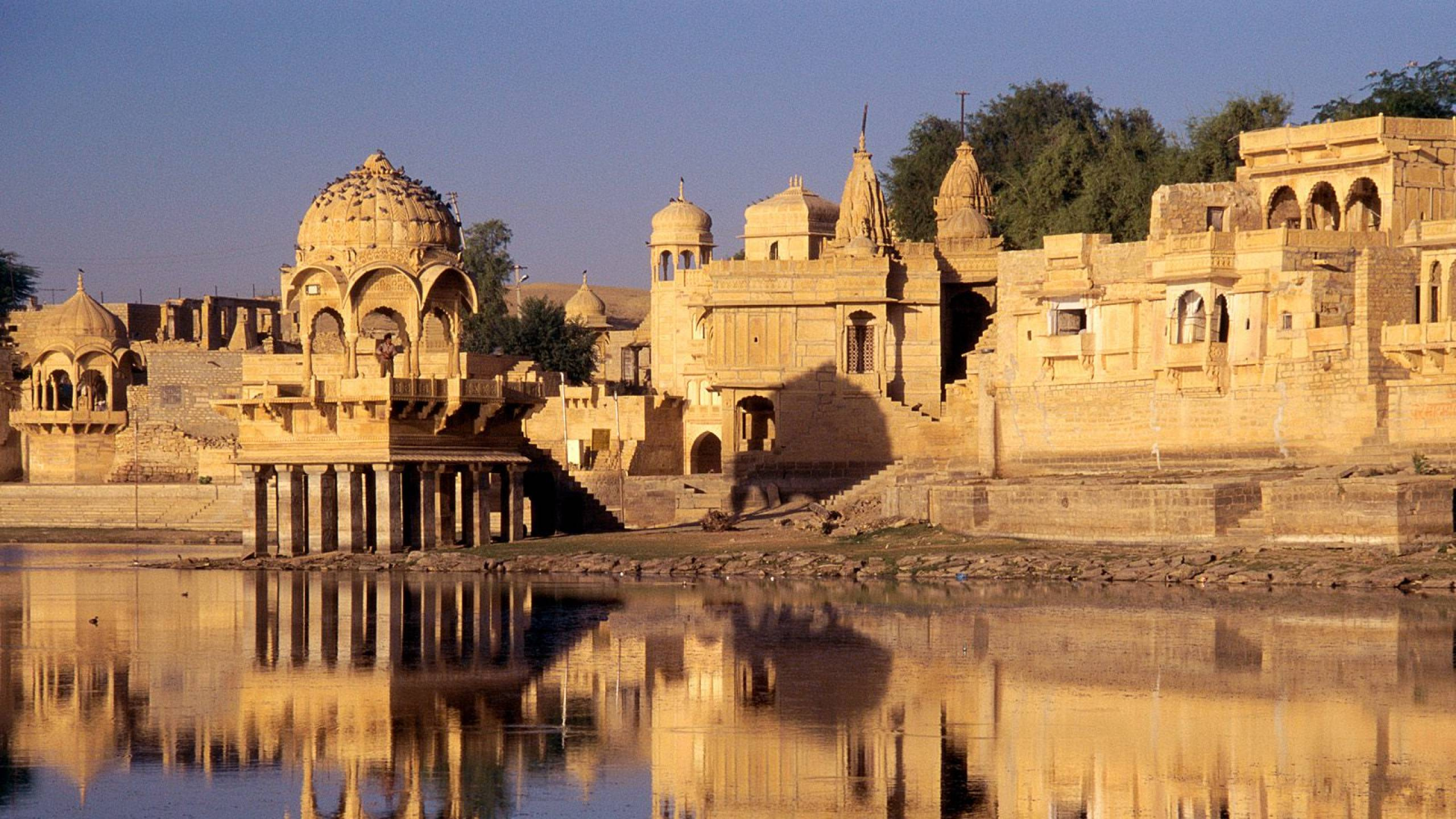 Edificio de Hormigón Marrón Cerca Del Cuerpo de Agua Durante el Día. Wallpaper in 2560x1440 Resolution