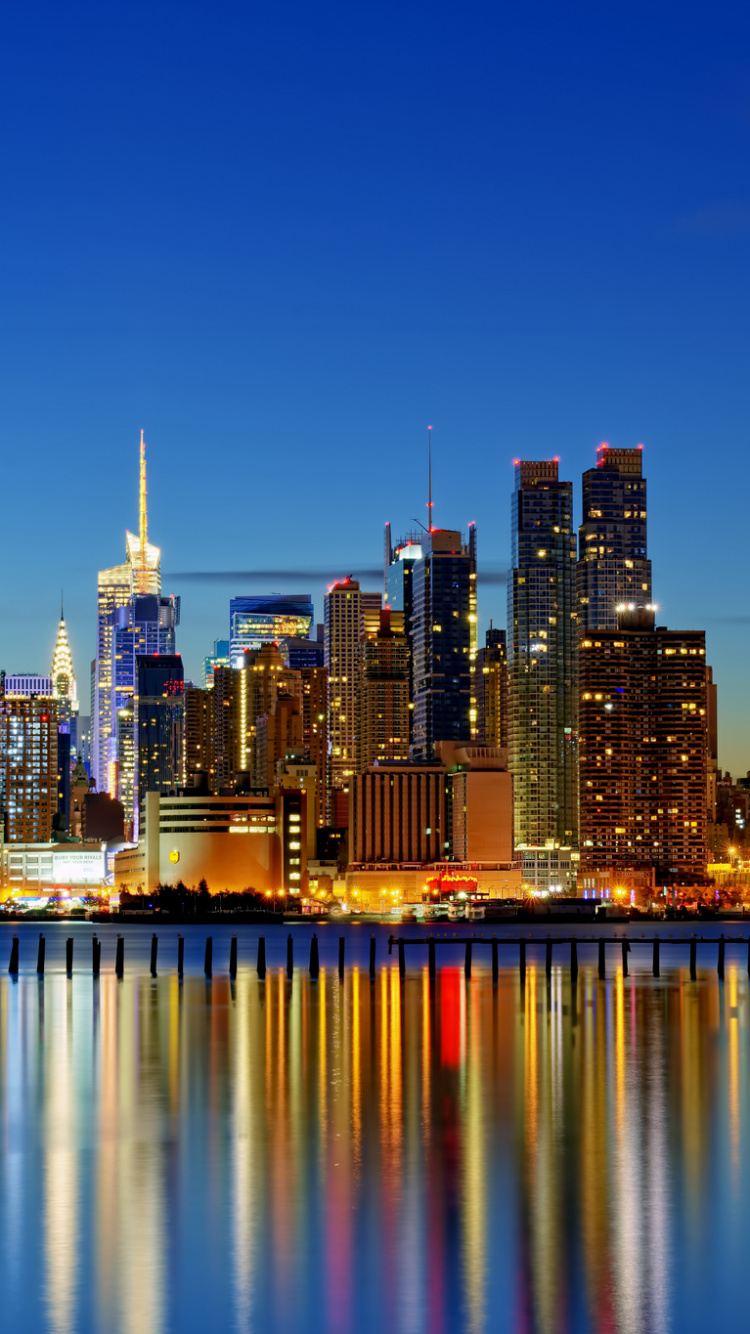 City Skyline Across Body of Water During Night Time. Wallpaper in 750x1334 Resolution