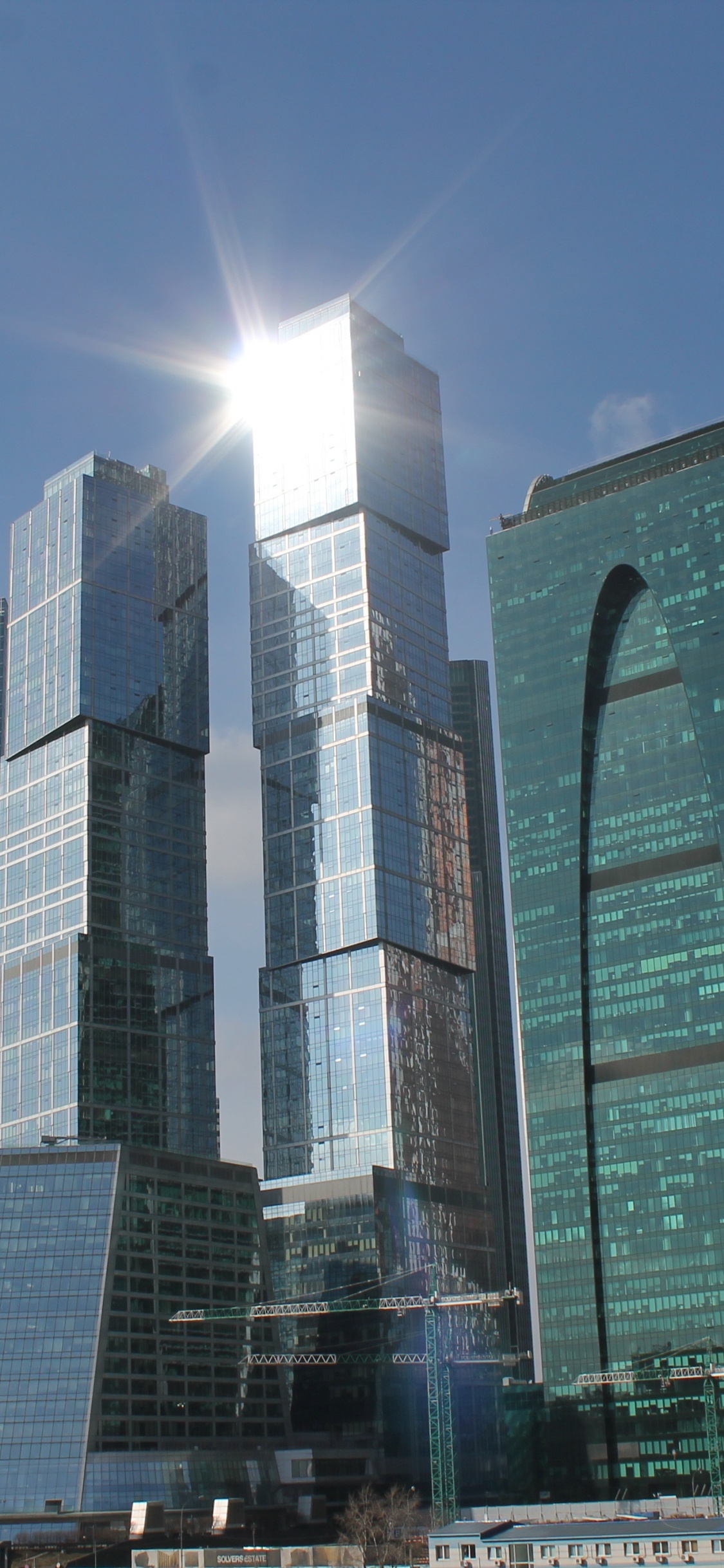 Green and Gray High Rise Building. Wallpaper in 1125x2436 Resolution