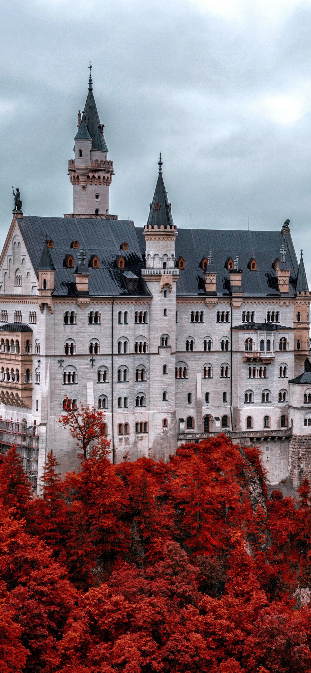 White and Blue Castle Surrounded by Trees Under Cloudy Sky During Daytime. Wallpaper in 1242x2688 Resolution