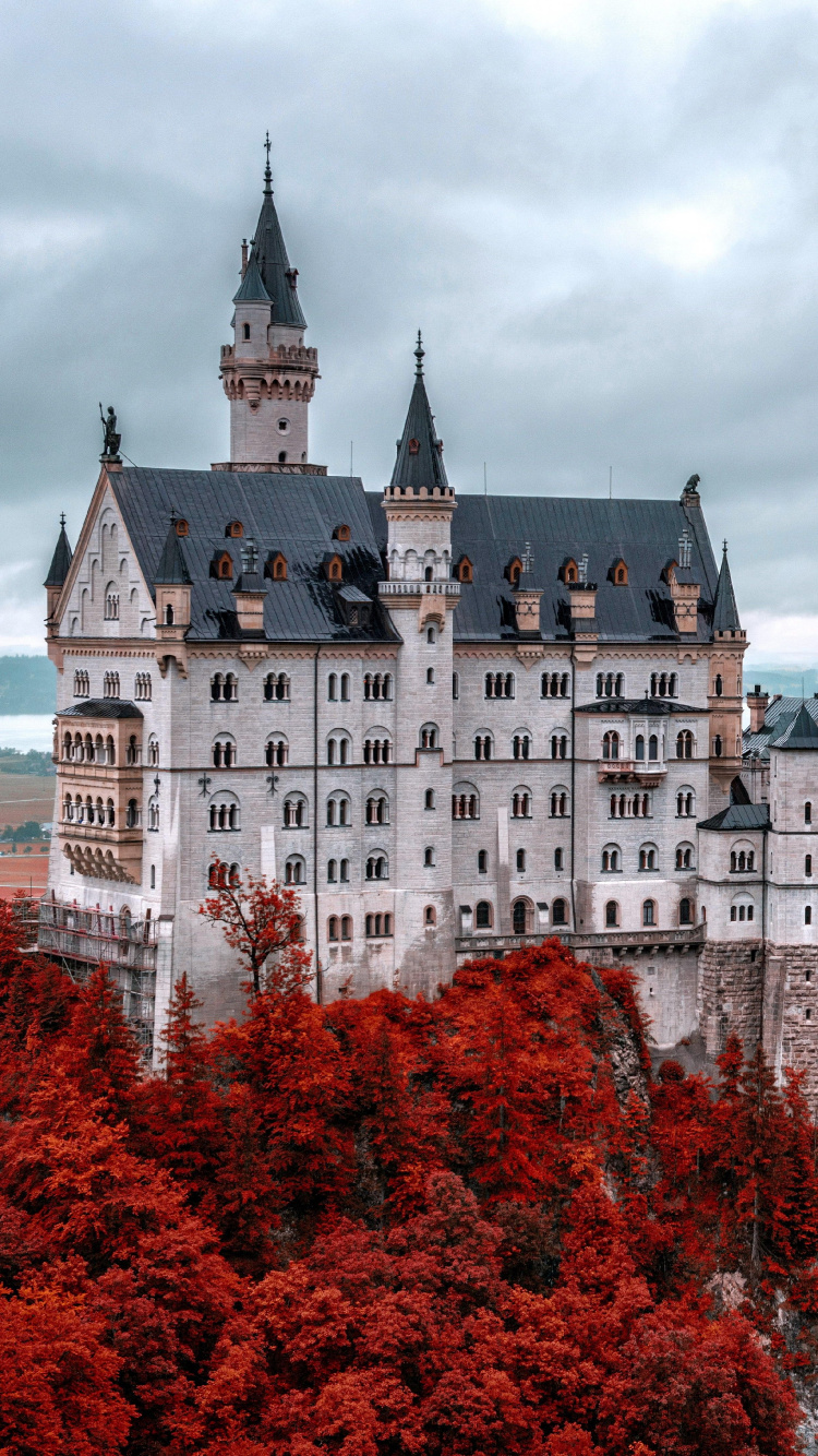 White and Blue Castle Surrounded by Trees Under Cloudy Sky During Daytime. Wallpaper in 750x1334 Resolution